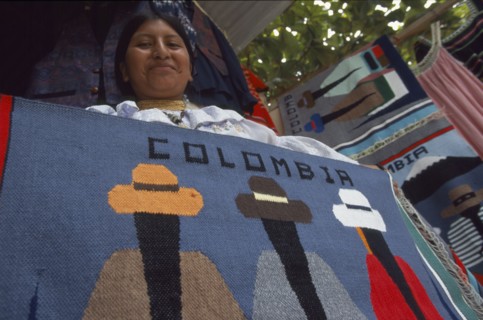 COLOMBIA, Amazonas, Leticia, Ecuadorean Otavalan Indian woman selling textile souvenirs.