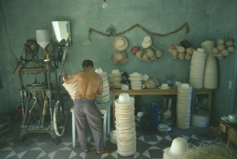 COLOMBIA, Narino Department, Sandona, Panama hat industry.  Male worker operating machinery with