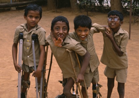 INDIA, Bangalore, Group of boys on crutches playing and laughing at The Institute for The Disabled.