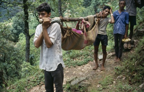 NEPAL, Health, Patient being carried in cloth stretcher.