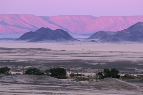 NAMIBIA, Namib Desert, Desert mountains and plains with pink and purple sky overhead