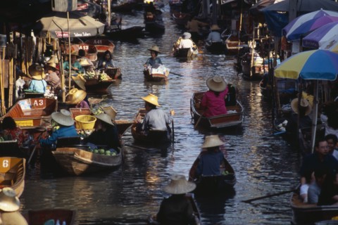 THAILAND, South, Bangkok, Damnoen Saduak Floating Market fruit vendors in their canoes on the main