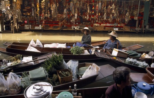 THAILAND, South, Bangkok, Damnoen Saduak Floating Market fruit vendors in their canoes with a