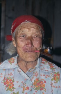 RUSSIA, Siberia, Lake Baikal, Portrait of elderly Buryat woman smoking pipe.