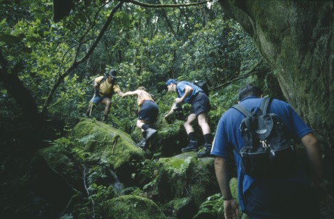 SEYCHELLES, Mahe Island, Local guide Basil Beaudouin leading tourists on Congo Rouge Trail.