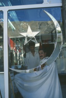 PAKISTAN, Northern Areas, Gilgit, Barbers shop with star and moon of the Pakistan flag inlaid on