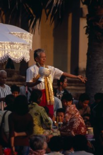 CAMBODIA, Siem Reap, Angkor Wat, Shaman at ceremony blessing devotees with the holy water