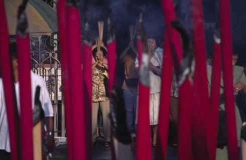 MALAYSIA, Penang, Georgetown, Kuan Yin Teng or Temple of Mercy with people carrying jos sticks and