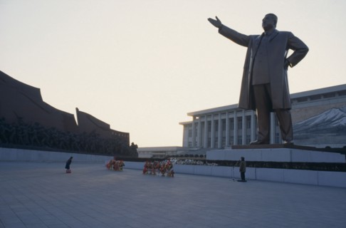 NORTH KOREA, Pyongyang, "Woman bowing in respect in front of statue of Kim II Sung, the Grand