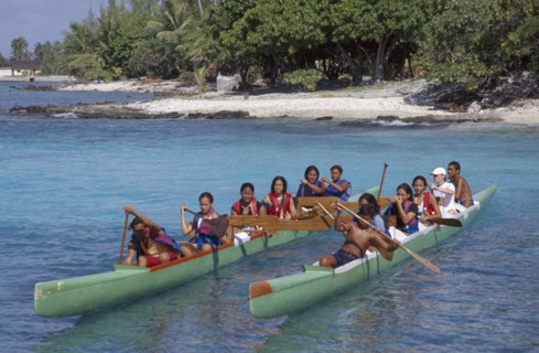 PACIFIC ISLANDS, French Polynesia, Tuamotu Islands, Ringiroa. Children paddling kayak.