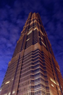 CHINA, Shanghai, Angled view looking up at the Hyatt Hotel skyscraper illuminated at dusk