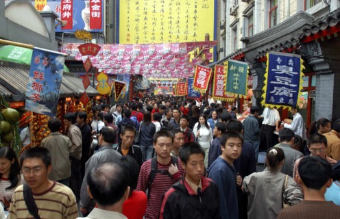 CHINA, Beijing, Busy street scene with shop banners