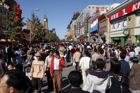 CHINA, Beijing, Busy commercial shopping area with clock tower in the distance