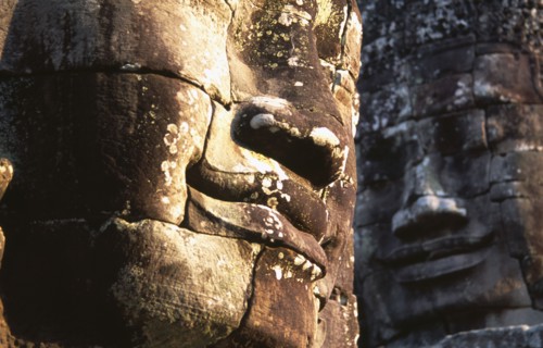 CAMBODIA, Siem Reap, Angkor Thom, Bayon Temple details of two of the four faced towers