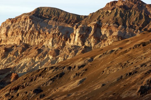 USA, California, Death Valley, View of red layered sculpted rock hills