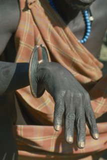 UGANDA, Karamoja, Tribal Poeple, Cropped shot of Karamojong Dodoth warrior displaying wrist knife