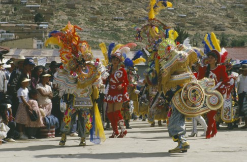 BOLIVIA, Oruro, La Diablada Carnival procession and spectators.