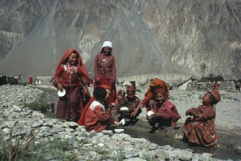 AFGHANISTAN, Tribal People, Group of Kirghiz children washing bowls in stream.