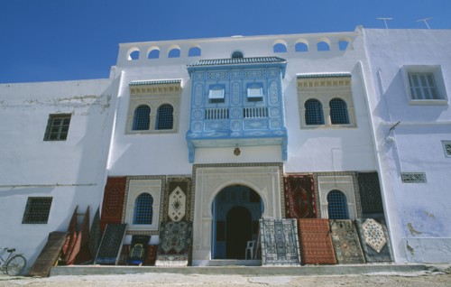 TUNISIA, Kairouan, Rug shop facade with display of rugs outside