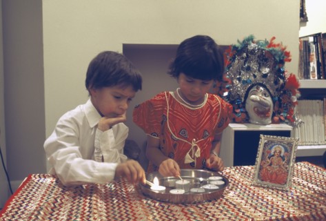 ENGLAND, Religion, Hinduism, Diwali Hindu Festival of lights with children lighting candles beside