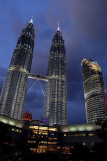 MALAYSIA, Kuala Lumpur, Angled view looking up at the Petronas Twin Towers illuminated at night