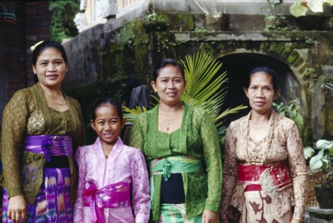 INDONESIA, Bali, Ubud, Family group of women and young girl on way to temple.