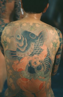 JAPAN, General, Heavily tattooed Yakuza gangster with back to camera.