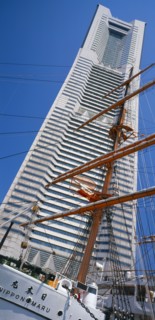 JAPAN, Honshu, Yokohama, View of the Nippon Maru tall ships mast with Landmark Tower skyscraper