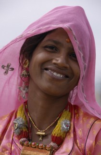 INDIA, Rajasthan, Thar Desert, Portrait of smiling Desert woman wearing pink in Bhansda Village.