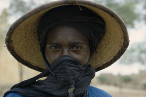 NIGERIA, People, Women, Portrait of a Fulani woman wearing a hat with a scarf covering her mouth.