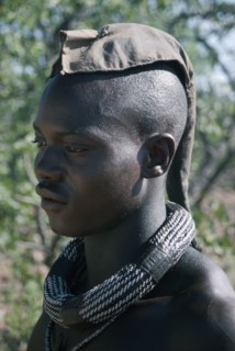 NAMIBIA, Skeleton Coast, Hoarusib Valley, Kaokoland.  Portrait of Himba man.  Cloth covering head