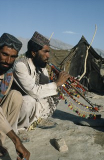 PAKISTAN, Music, Afghan man playing traditional pipes.