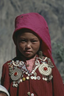 AFGHANISTAN, Nomadic People, Head and shoulders portrait of young Kirghiz girl.