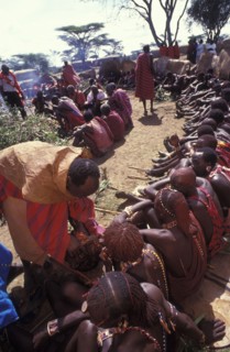 KENYA, Kajiado, Maasai Moran have the fat from a sacrificial cow daubed on them as well as taking a