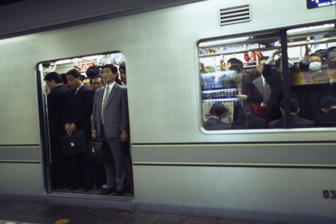 JAPAN, Honshu, Tokyo, Subway train at a platform with passengers crowded on