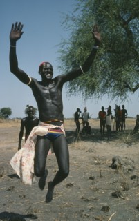 SUDAN, People, Dinka tribesman leaping into air.