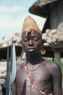 SUDAN, Tribal Peoples, Portrait of Dinka boy holding spears.