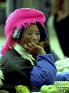 CHINA, Yunnan, Zongdian, Portrait of a female street vendor wearing a pink hat