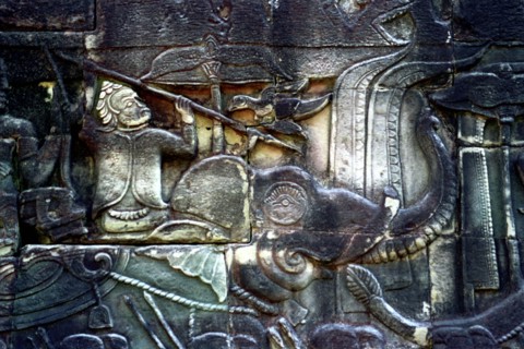 CAMBODIA, Angkor, The Bayon. Carved detail of the pyramid temple built in the centre of the ancient