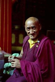 INDIA, Sikkim, Rumtek Gompa, Portrait of monk performing Pujar ceremony  and the making of a