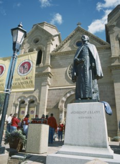 USA, New Mexico, Santa Fe, St Francis Cathedral with staue of J B Lamy in the foreground