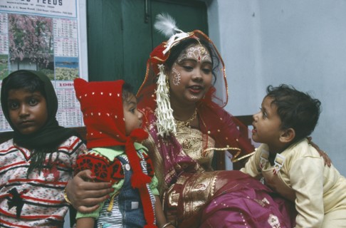INDIA, West Bengal, Wedding, Hindu bride with children.