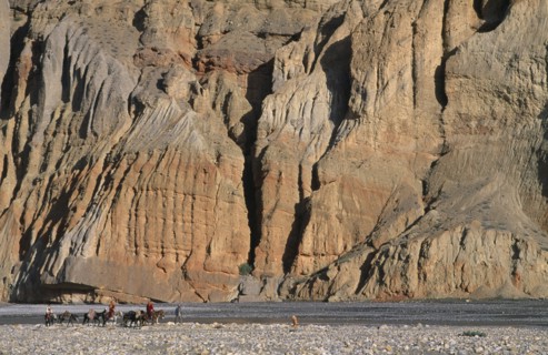 NEPAL, Mustang, High ranking Tibetan lama and Monks travelling across landscape by sheer cliffs to