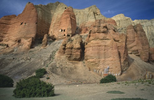 NEPAL, Mustang, The red cliffs of Drakhmar with Buddhist shrine at the base
