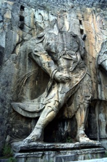 CHINA, Henan, Near Luoyang, Ancient Longmen caves. One of the many beheaded images of Buddha and
