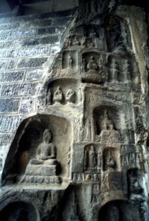 CHINA, Henan, Near Luoyang, Ancient Longmen caves. Images of Buddha and his disciples carved in to