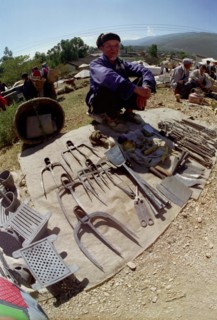 CHINA, Yunnan, Shapin, Wide angle view of market stall vendor and display of tools