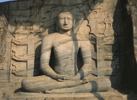 SRI LANKA, Polonnaruwa, Gal Vihara.  Mid twelth century seated Buddha figure carved from granite.
