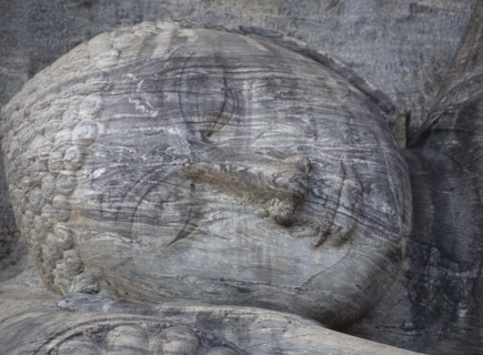SRI LANKA, Polonnaruwa, Gal Vihara.  Mid twelth century reclining Buddha figure shown at the moment
