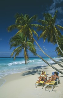WEST INDIES, Barbados, Christ Church, Worthing beach with tourists sunbathing on loungers